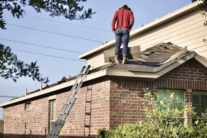 Professional roofer working on a residential roof in Warrens Mill